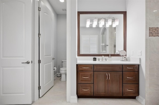 bathroom with vanity, tile patterned floors, and toilet