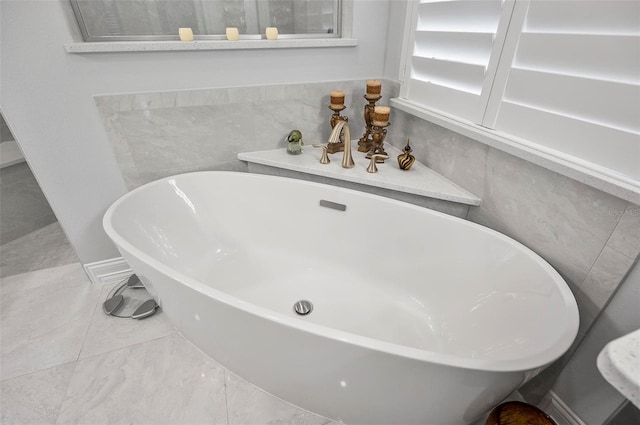 bathroom with a relaxing tiled tub