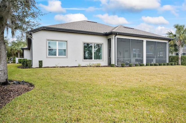 back of property with a lawn and a sunroom