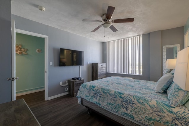 bedroom featuring a textured ceiling, ceiling fan, and dark wood-type flooring