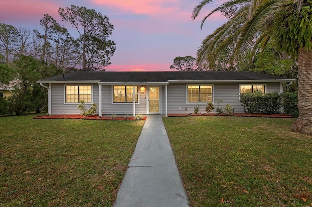 ranch-style house featuring a lawn