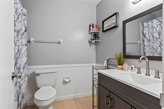 bathroom featuring vanity, tile patterned floors, and toilet