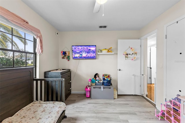 bedroom featuring ceiling fan and light hardwood / wood-style flooring