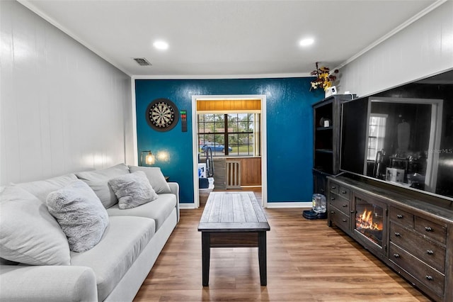 living room with ornamental molding and hardwood / wood-style flooring