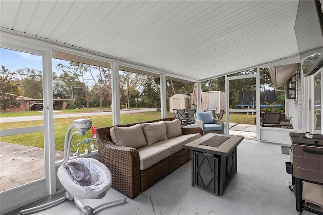 sunroom / solarium featuring vaulted ceiling and plenty of natural light