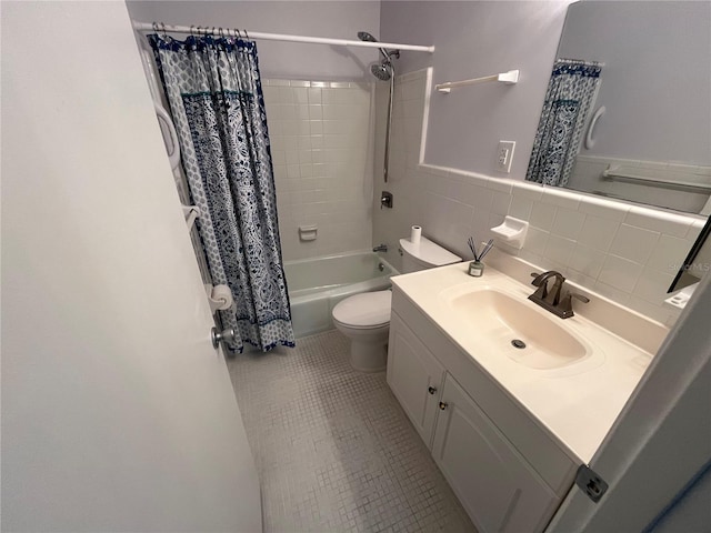 full bathroom featuring shower / tub combo, tile walls, vanity, tile patterned floors, and toilet