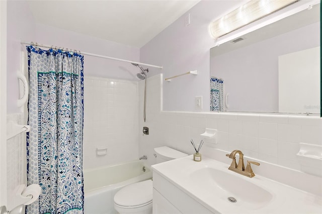 full bathroom with vanity, toilet, shower / tub combo, and tile walls