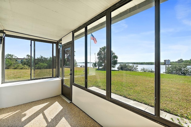 unfurnished sunroom featuring a water view