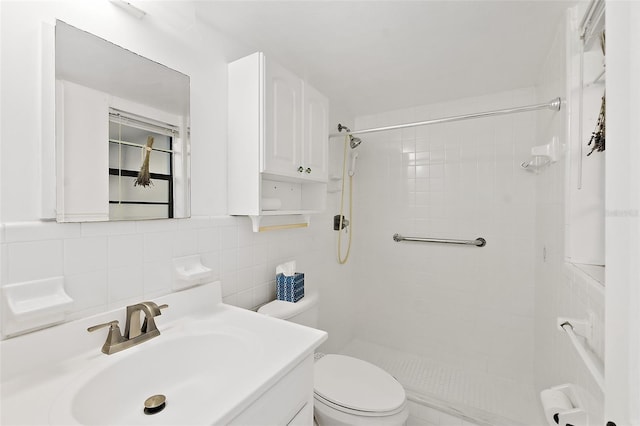 bathroom with tile walls, tiled shower, vanity, decorative backsplash, and toilet