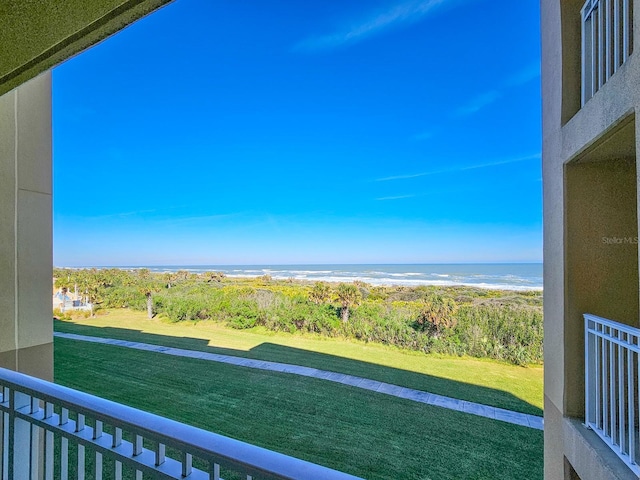 balcony featuring a water view and a beach view