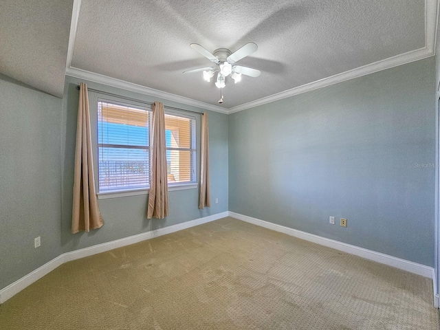 carpeted spare room featuring crown molding, ceiling fan, and a textured ceiling