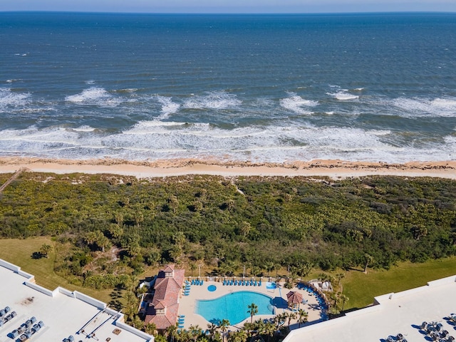 aerial view with a water view and a beach view