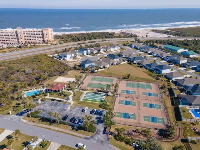 drone / aerial view with a water view and a beach view