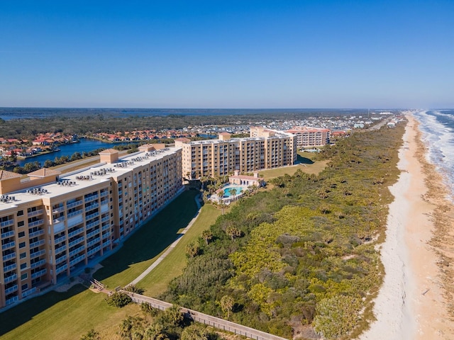 drone / aerial view featuring a beach view and a water view