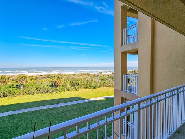 balcony featuring a water view and a view of the beach