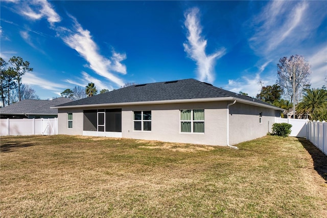 rear view of property with a lawn