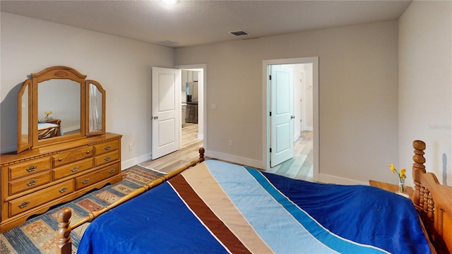 bedroom featuring hardwood / wood-style floors and a textured ceiling