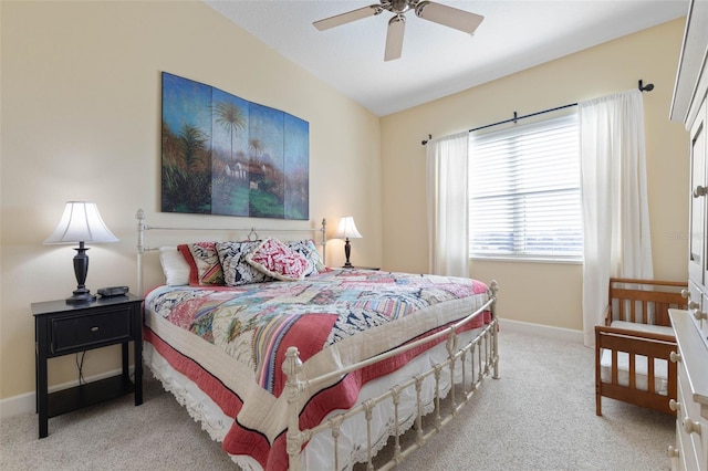 bedroom featuring lofted ceiling, light colored carpet, and ceiling fan