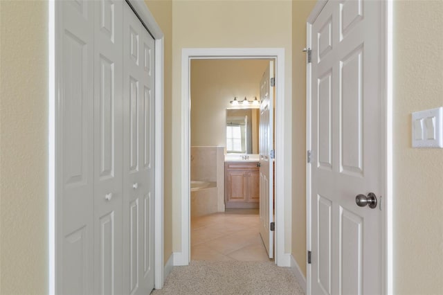 hallway with light colored carpet