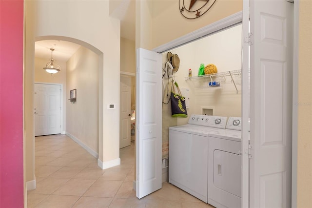 washroom with separate washer and dryer and light tile patterned floors