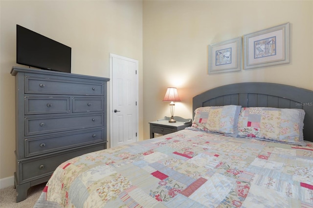 bedroom featuring light carpet