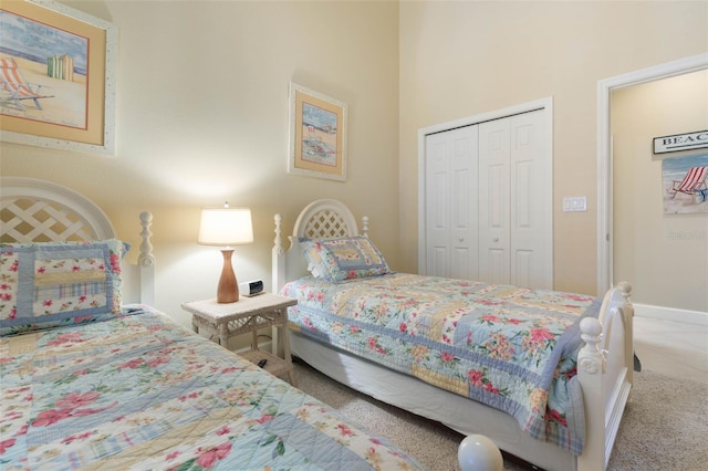 bedroom featuring carpet floors, a closet, and a high ceiling