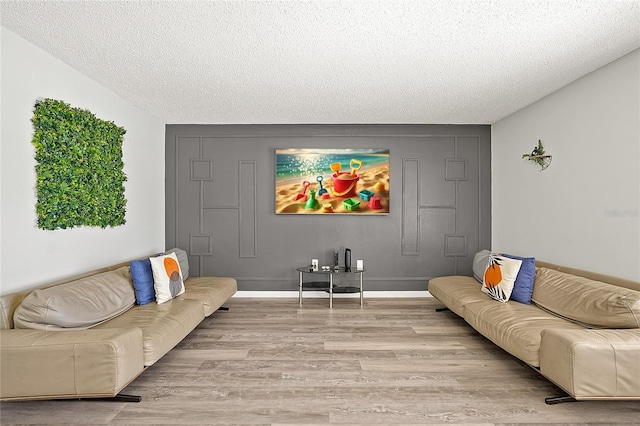 living room with a textured ceiling and light hardwood / wood-style flooring