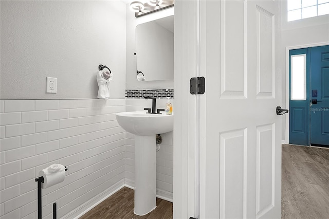 bathroom with sink, hardwood / wood-style floors, and backsplash