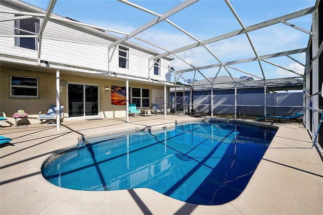 view of swimming pool featuring a lanai and a patio area