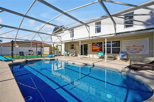 view of pool featuring a patio area and glass enclosure