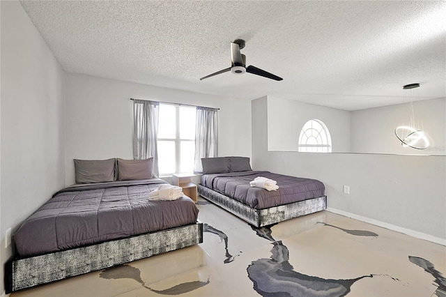 bedroom featuring a textured ceiling, concrete flooring, and ceiling fan