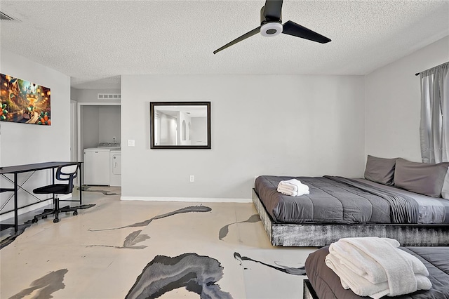 bedroom featuring ceiling fan, concrete flooring, washer and clothes dryer, and a textured ceiling