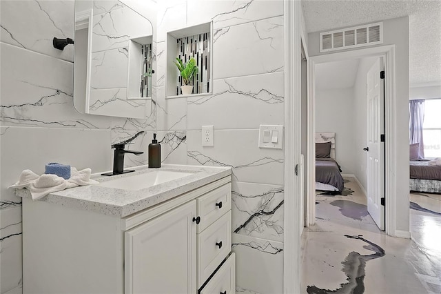 bathroom featuring vanity and a textured ceiling