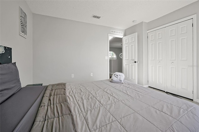 unfurnished bedroom with a textured ceiling and a closet