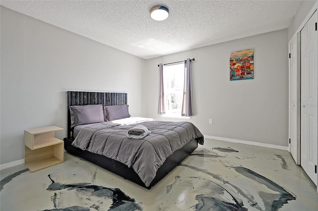 bedroom featuring a textured ceiling and a closet