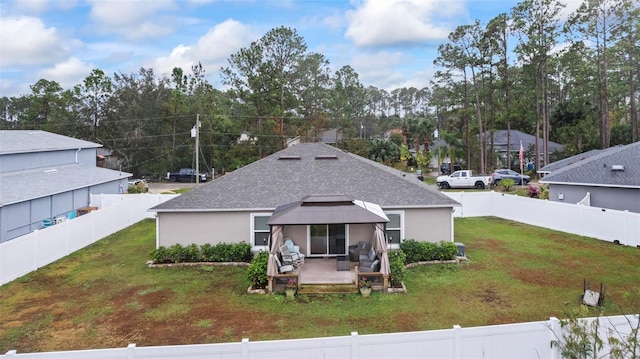 back of house featuring a yard, a patio, and a gazebo