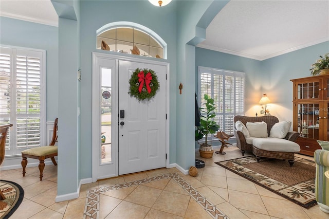 tiled foyer entrance with plenty of natural light and ornamental molding