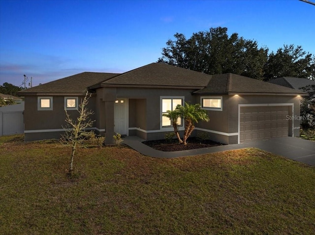 view of front facade with a lawn and a garage