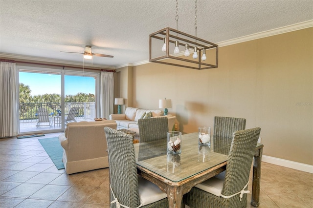 tiled dining room featuring ceiling fan, crown molding, and a textured ceiling