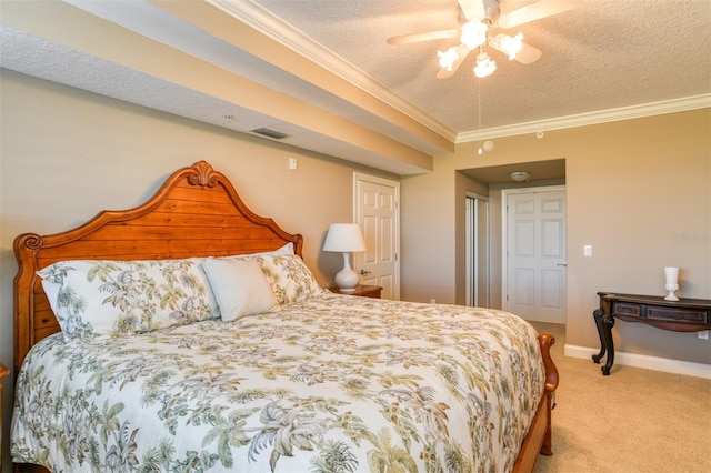 carpeted bedroom with ornamental molding, a textured ceiling, and ceiling fan