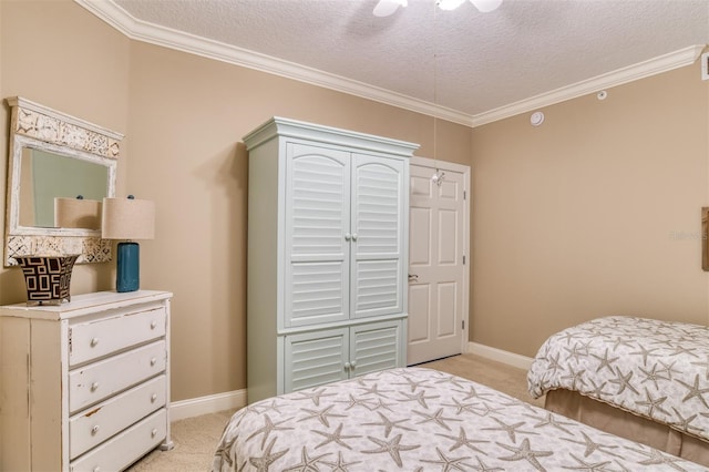 bedroom featuring ceiling fan, ornamental molding, light carpet, and a textured ceiling