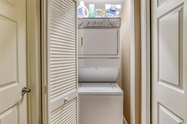 laundry area featuring stacked washing maching and dryer