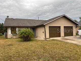 ranch-style house featuring a front lawn and a garage