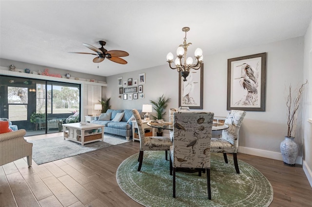 dining room featuring ceiling fan with notable chandelier and hardwood / wood-style flooring