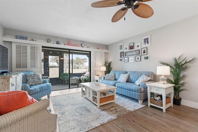 living room with ceiling fan and hardwood / wood-style flooring