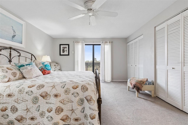 carpeted bedroom featuring ceiling fan, multiple closets, and access to outside