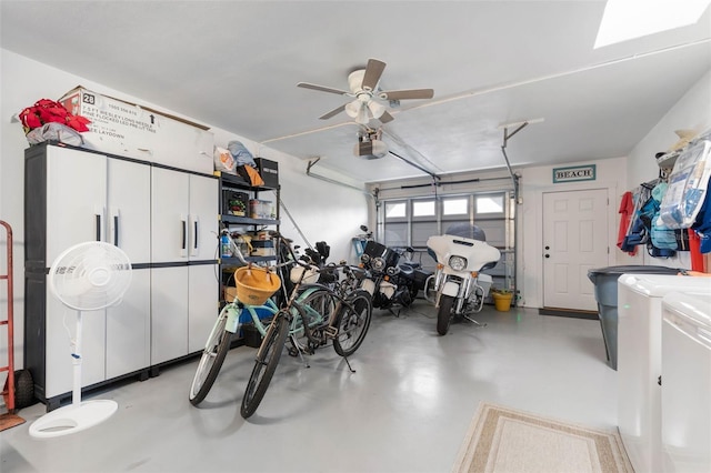 garage featuring a garage door opener, independent washer and dryer, and ceiling fan