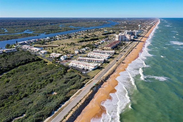 drone / aerial view with a water view and a beach view