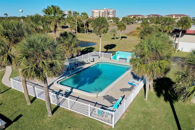 view of swimming pool featuring a lawn and a patio