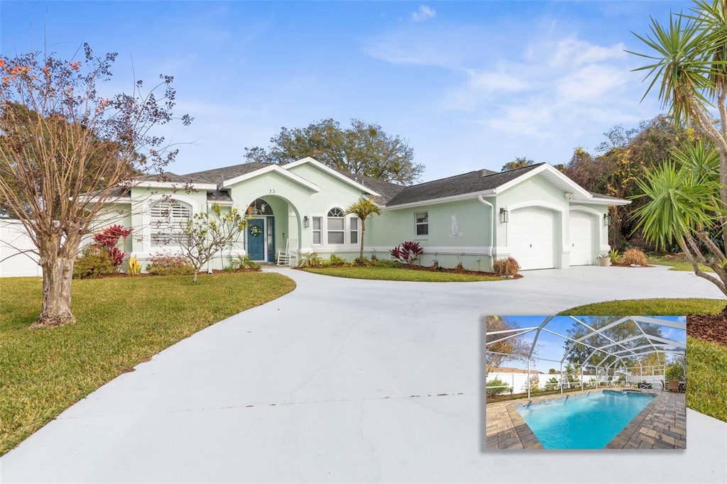 ranch-style house featuring a front yard and a garage